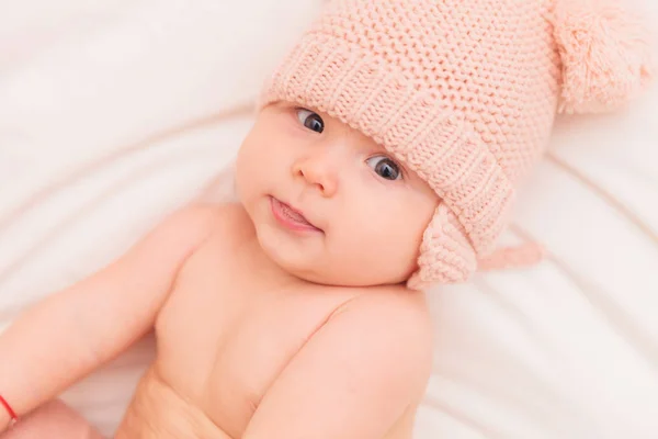 Adorable 5 months old baby gisr wearing knitted hat