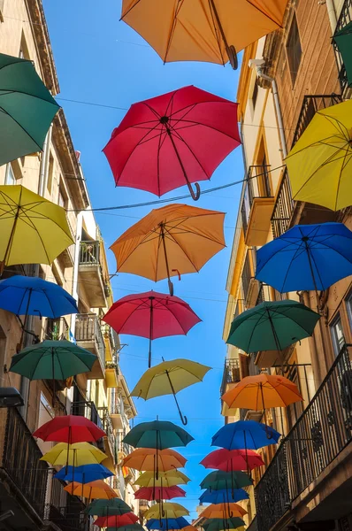 Antique street decorated with colored umbrellas.