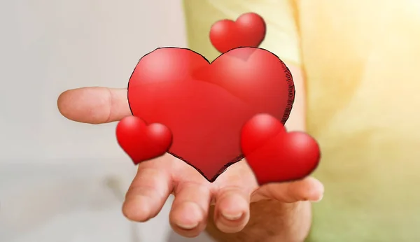 Young man holding hand drawn red heart