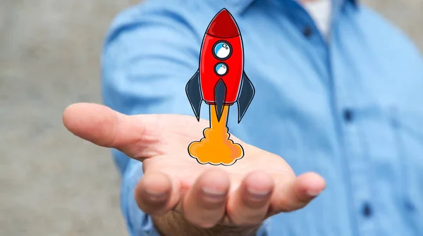 Businessman holding red hand drawn rocket in his hand
