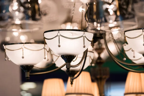Different chandeliers in a lighting shop