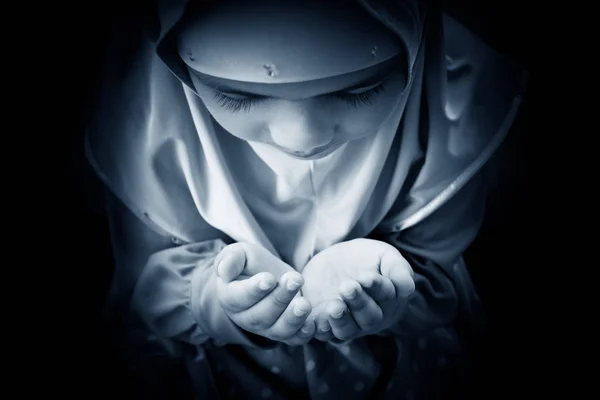 Young muslim woman praying in mosque. raising his hands, ending