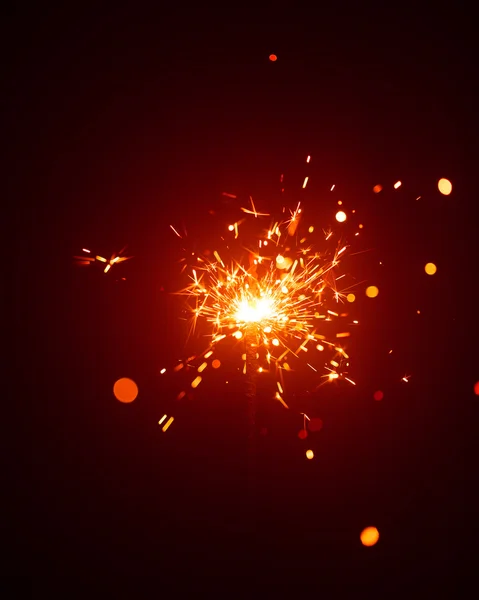 Christmas sparkler in haze with red light