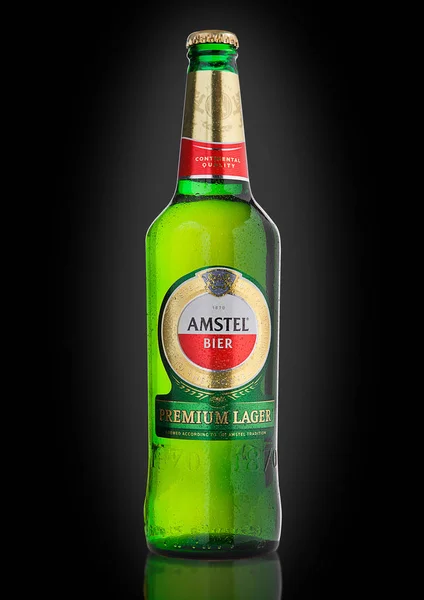 LONDON, UNITED KINGDOM - NOVEMBER 01, 2016: Cold bottle of Amstel Premium Lager on black background.Amstel is an internationally known brand of beer produced by Heineken International in Zoeterwoude,