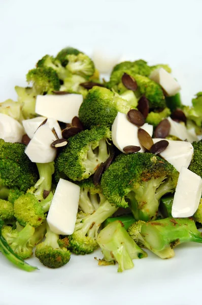 Healthy lunch, broccoli with fresh mozzarella and pumpkin seeds