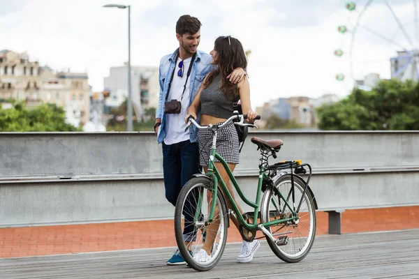 Happy young couple cycling in the city.
