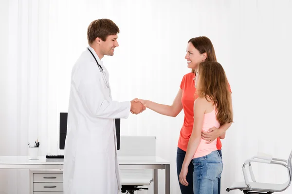 Doctor Handshaking Girl Mother