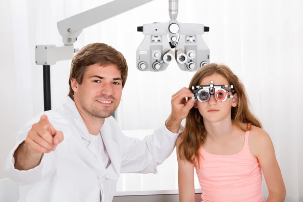 Optometrist Checking Girl's Vision