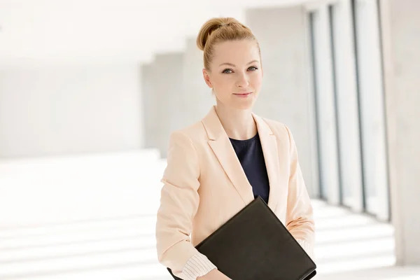 Businesswoman holding file in office