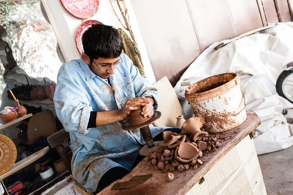 Artist works on a traditional ceramic vase in Cappadocia