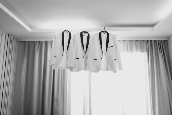 Business man suit clothes hanging. groom jacket