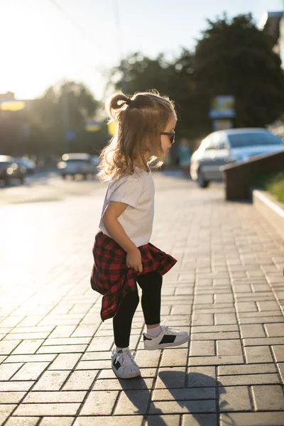 Stylish funny hipster little girl on street