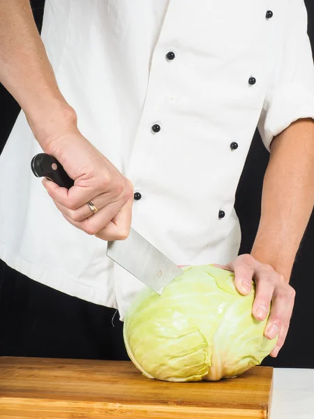 Professional chef holding a sharp cooking knife onto a whole cab