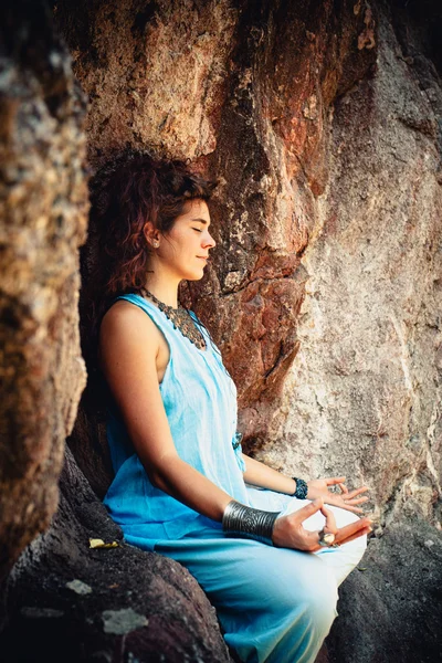 Woman meditation on rock