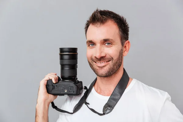 Portrait of a happy handsome man holding camera