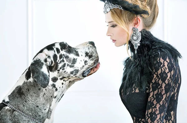 Elegant young woman staring at the dog