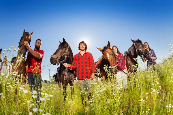 Equestrians walking with their horses