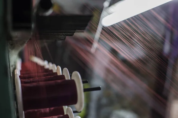 Thread reels of the weaving loom.