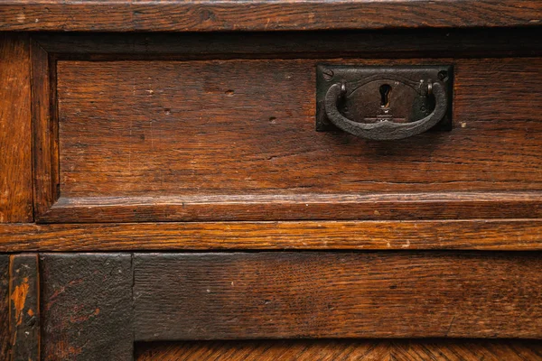 Background, texture of ancient wooden furniture close up. vintage drawer closeup, retro sideboard