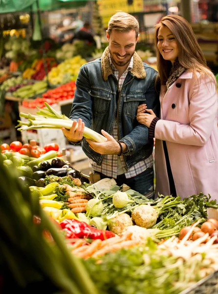 Loving couple at vegetable market