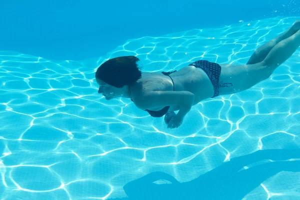 Female swimming in pool