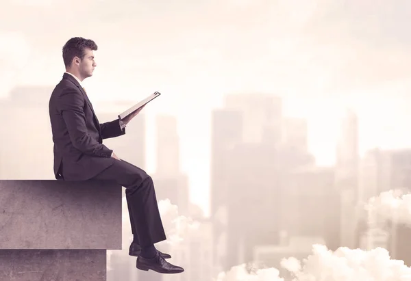 Peaceful sales guy sitting on roof top