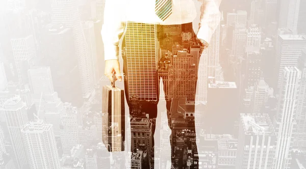 Business person with warm color overlay of city background