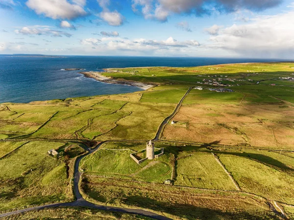 Aerial Famous Irish Tourist Attraction In Doolin, County Clare, Ireland. Doonagore Castle is a round 16th-century tower Castle. Aran Islands and along The Wild Atlantic Way.