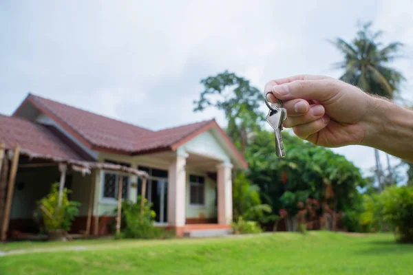 Holding in his hand the keys of the house. Buying, selling, renting house.