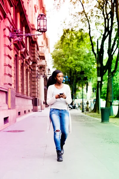Black woman walking outdoor in city