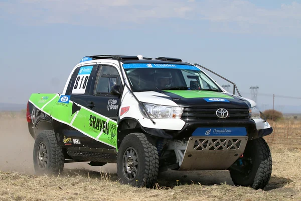 Close-up view of Speeding green and white Toyota Hilux twin cab