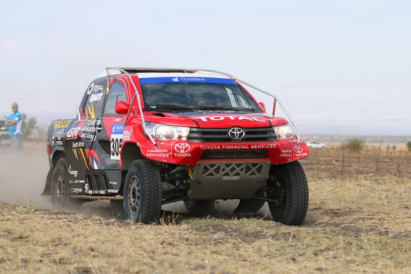 Close-up view of Speeding red and black Toyota Hilux twin cab ra