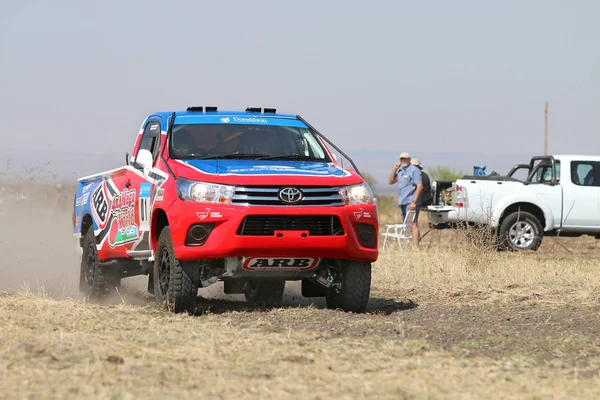 Close-up view of Speeding red and blue Toyota Hilux single cab r