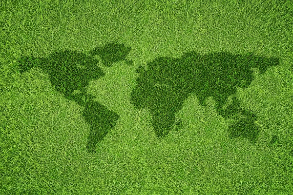 World map shape on green grass field background