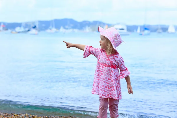 Little girl in pink dress. Russell Long Beach, Bay of islands. NZ