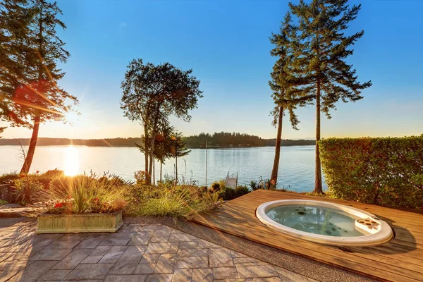 Exterior of waterfront house with jacuzzi at the back yard..