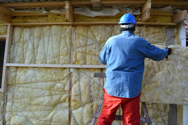 Builder  insulating wooden house with mineral  wool