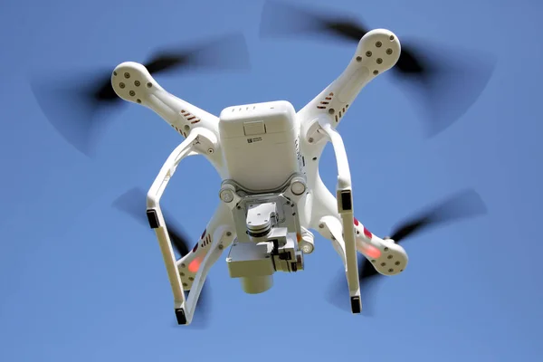 Drone flying with clear blue sky