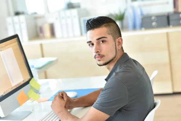 student in front of desktop computer