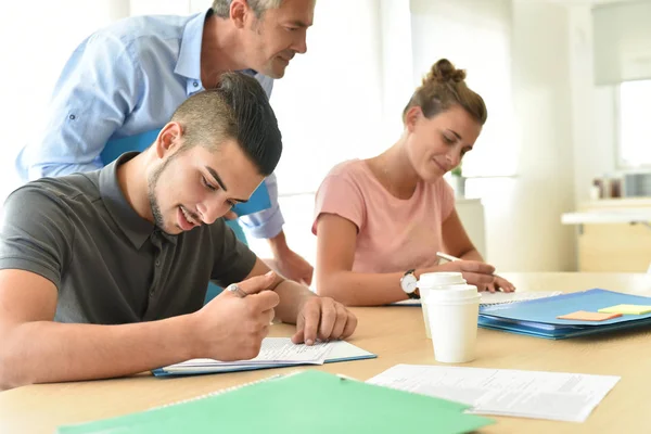 students filling in registration forms