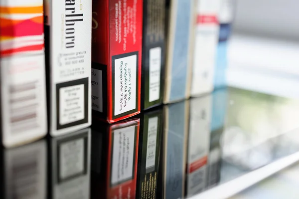 Multiple cigarettes pack on glass table