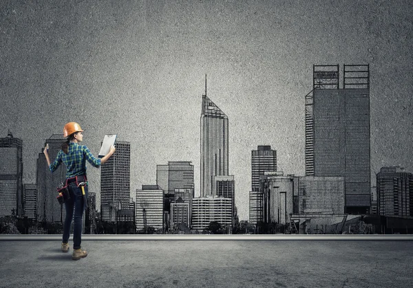 Woman with folder and sketches of construction project