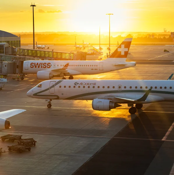 PRAGUE - August 13, 2016: Commercial airplanes at Vaclav Havel Airport Prague on April 7, 2016, boarding passengers in beautiful sunset
