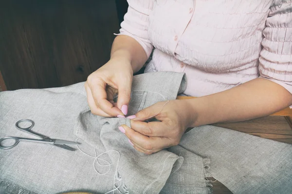 Woman hands doing openwork embroidery
