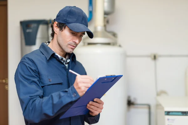 Technician servicing an hot-water heater