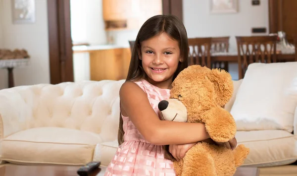 Little girl holding a teddy bear