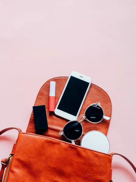 Woman bag with cosmetics and smartphone