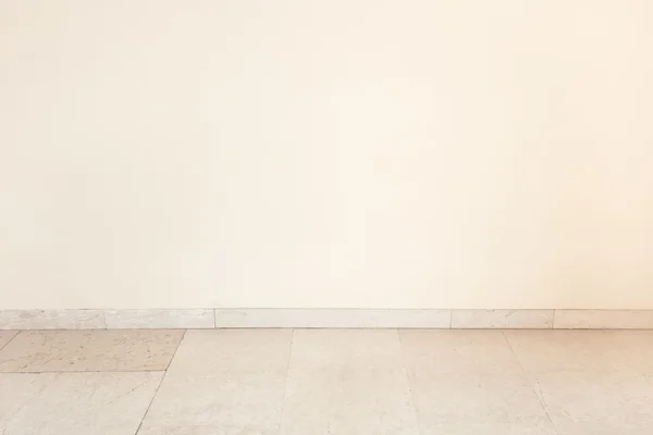 Marble floor in empty room, blank wall