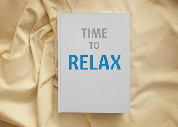 Text TIME TO RELAX on white book cover. Leisure concept.