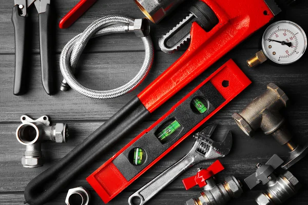 Plumber tools on background